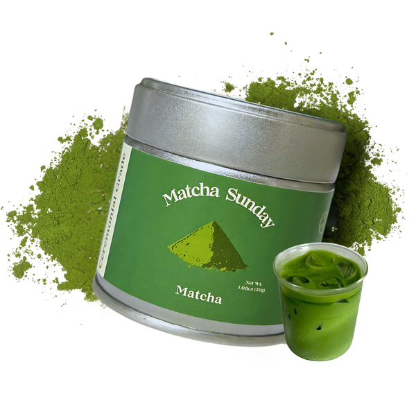 Matcha Sunday ceremonial grade matcha tin beside a glass of iced matcha latte on a green powder splash