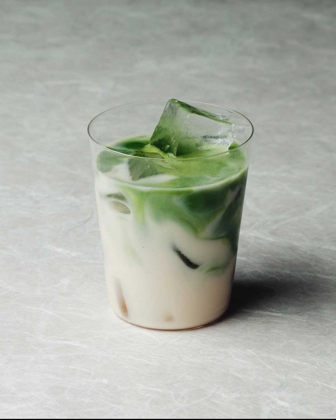 A vivid green iced matcha in a clear glass