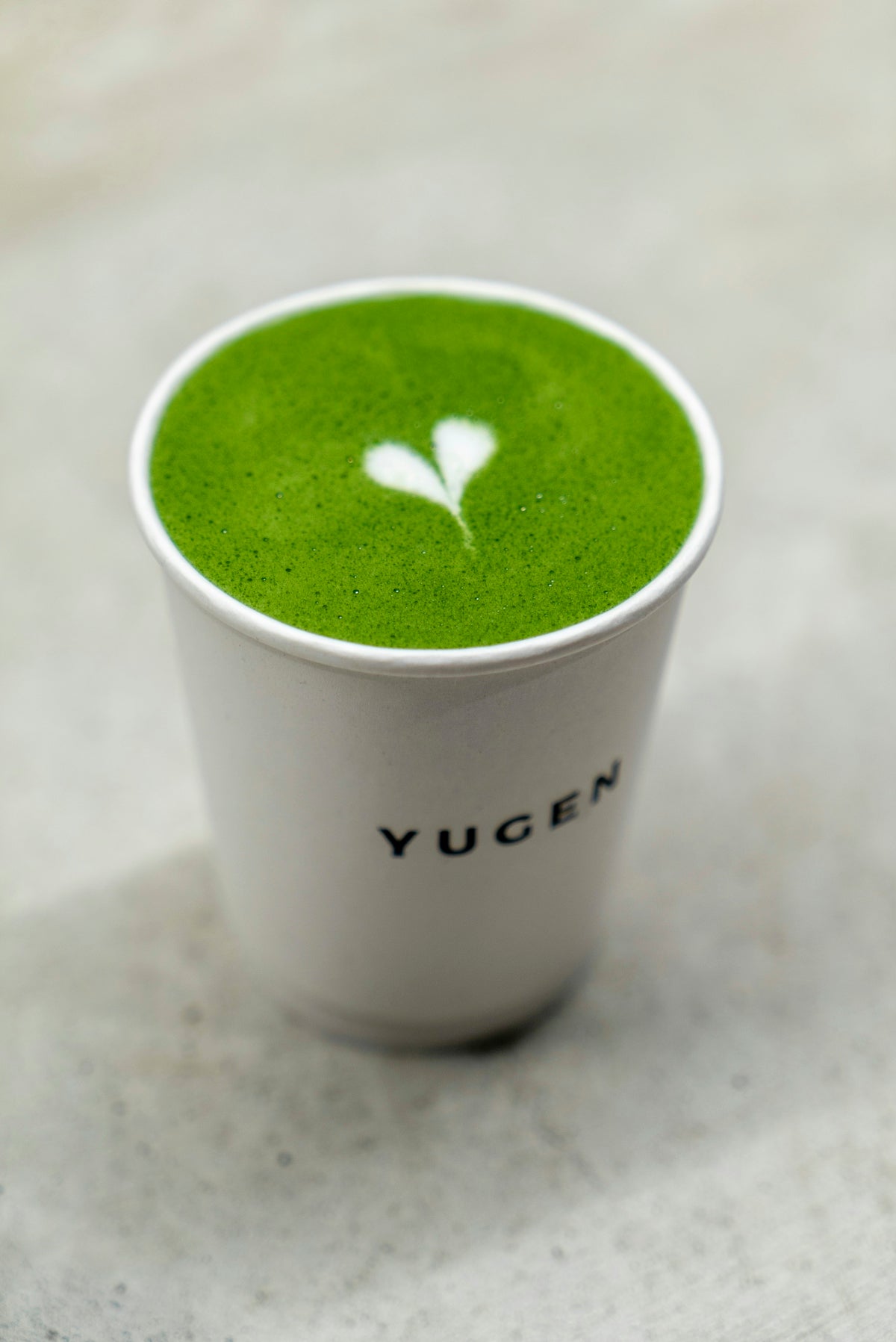white and green disposable cup