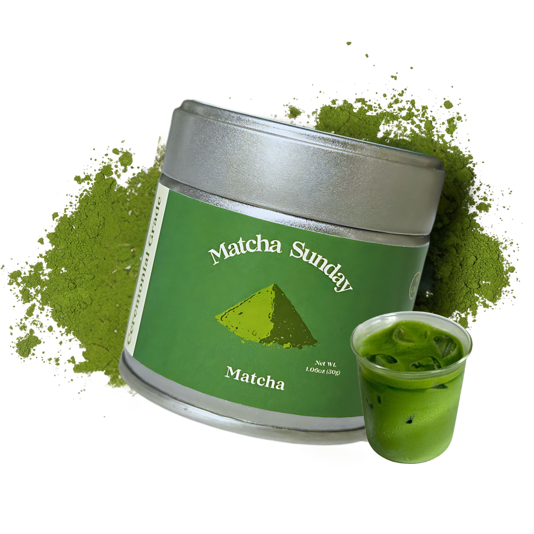 Matcha Sunday ceremonial grade matcha tin beside a glass of iced matcha latte on a green powder splash